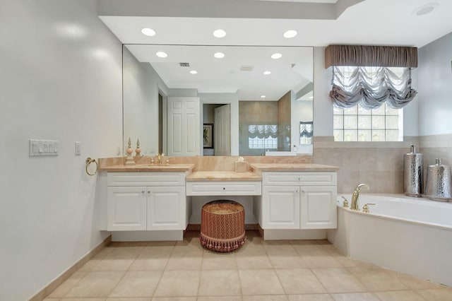 bathroom with tile patterned floors, recessed lighting, a bath, and vanity