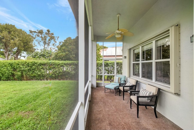 sunroom featuring a ceiling fan