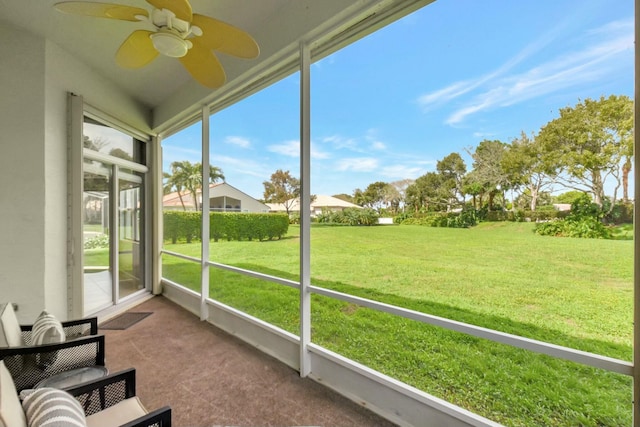 unfurnished sunroom featuring ceiling fan