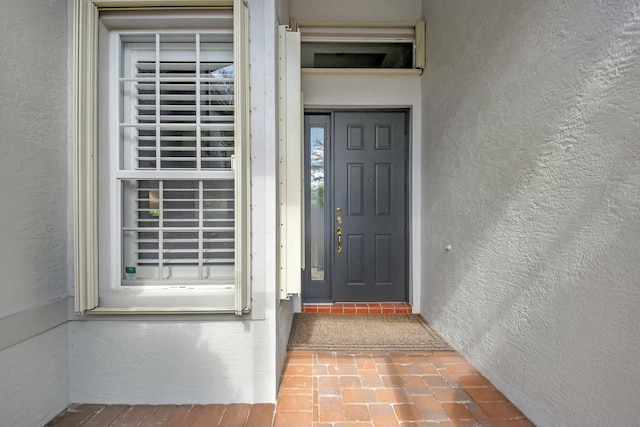 entrance to property with stucco siding