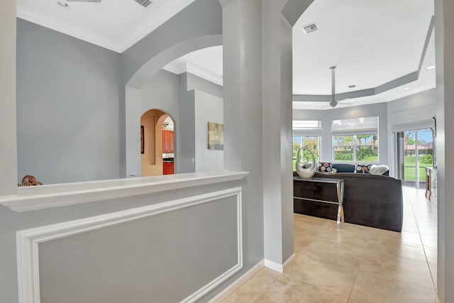 corridor with arched walkways, tile patterned flooring, recessed lighting, visible vents, and ornamental molding