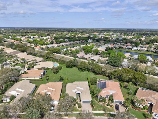 drone / aerial view featuring a residential view and a water view