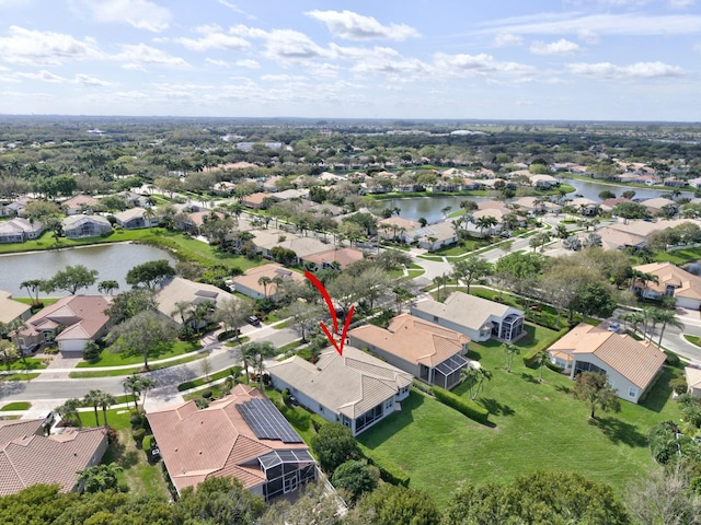 drone / aerial view featuring a water view and a residential view