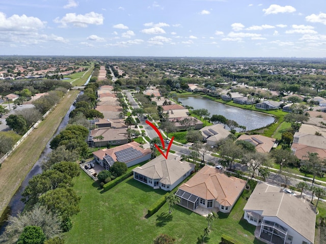 drone / aerial view featuring a water view and a residential view