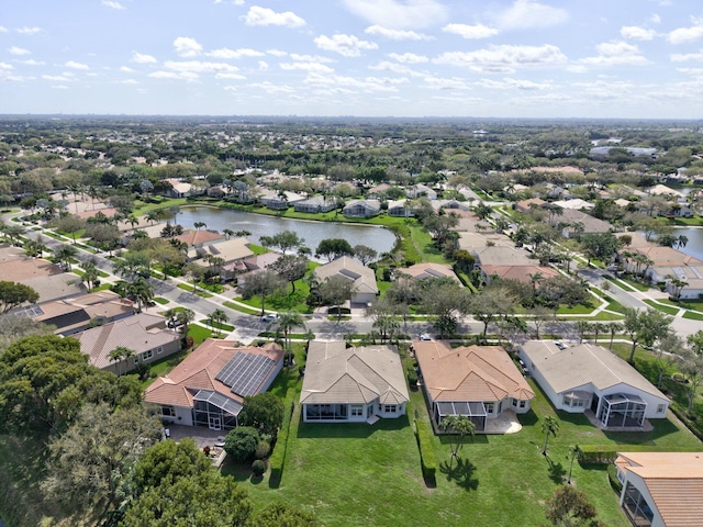 birds eye view of property with a water view and a residential view