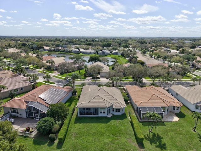 birds eye view of property featuring a water view and a residential view