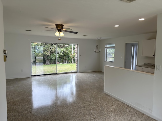 unfurnished room with baseboards, light speckled floor, visible vents, and recessed lighting