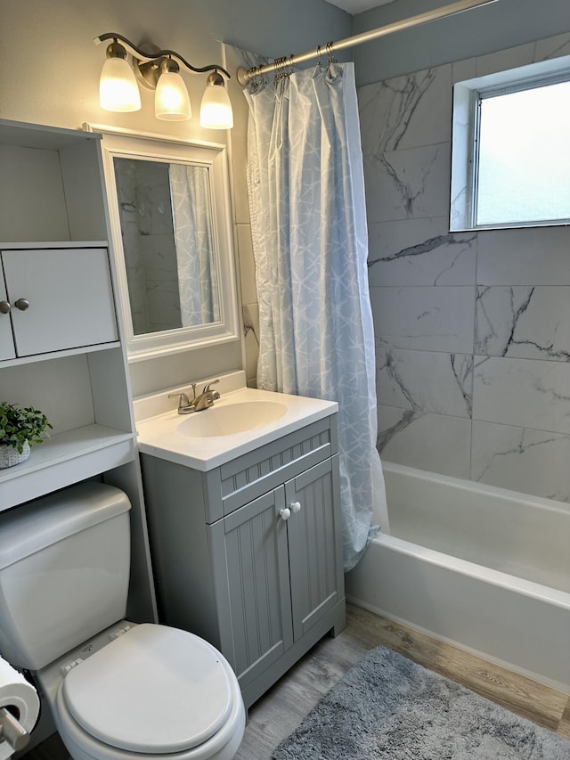 full bathroom with shower / bath combo, vanity, toilet, and wood finished floors