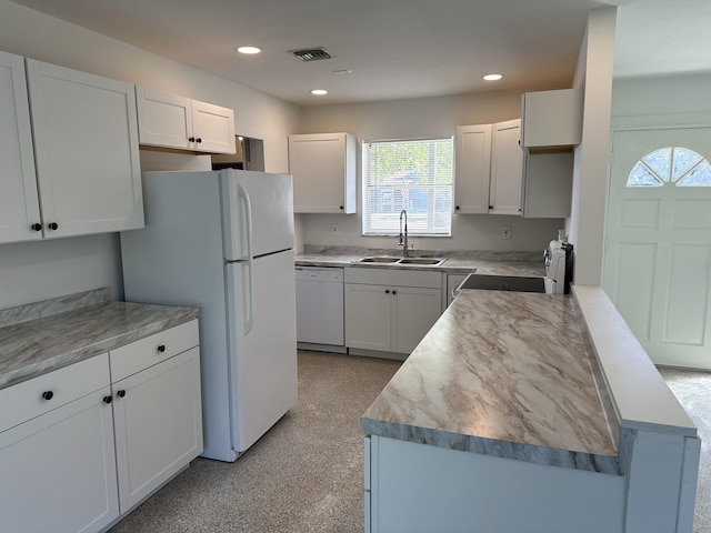 kitchen featuring light countertops, white appliances, white cabinetry, and a sink