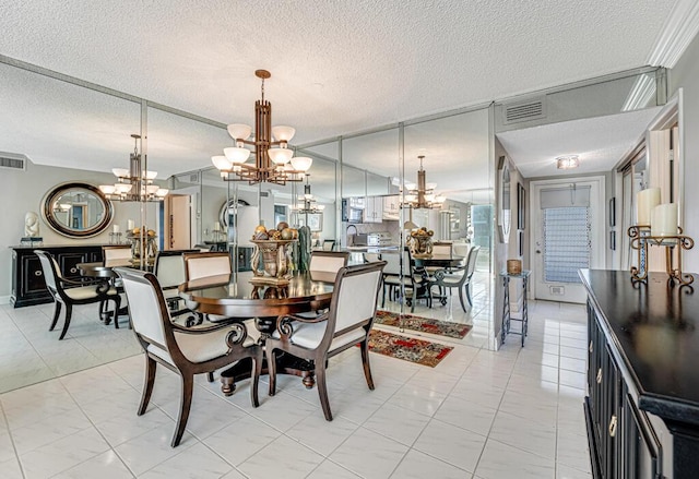 dining room with a chandelier, visible vents, and a textured ceiling