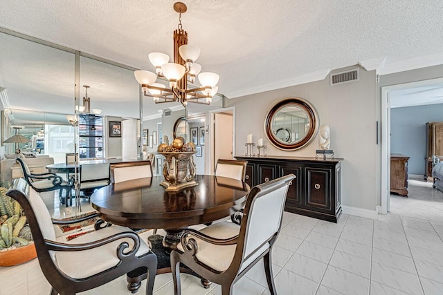 dining room with visible vents, ornamental molding, a textured ceiling, a chandelier, and baseboards