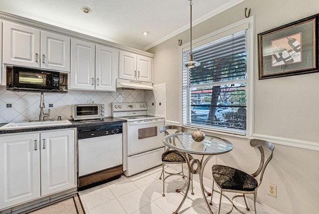 kitchen featuring white appliances, a toaster, ornamental molding, under cabinet range hood, and a sink