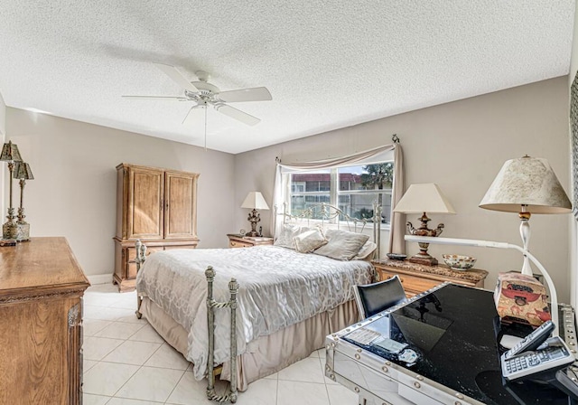 bedroom with ceiling fan, a textured ceiling, and light tile patterned floors