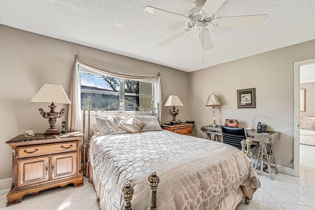 bedroom with connected bathroom, light tile patterned flooring, ceiling fan, and a textured ceiling