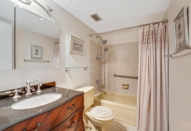 bathroom with toilet, visible vents, shower / bath combo with shower curtain, and vanity