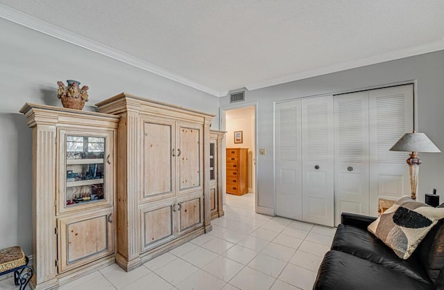 sitting room with visible vents, ornamental molding, and light tile patterned flooring