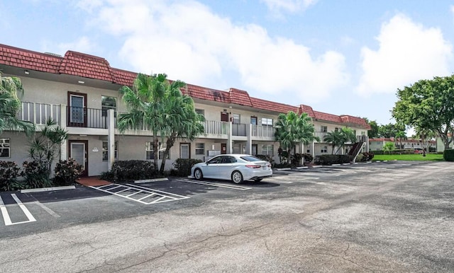 view of property featuring uncovered parking