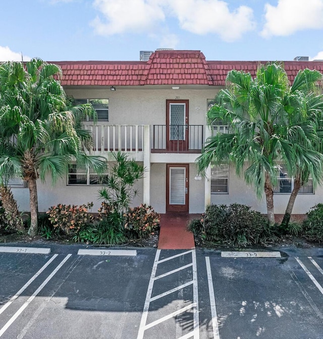 view of property featuring uncovered parking