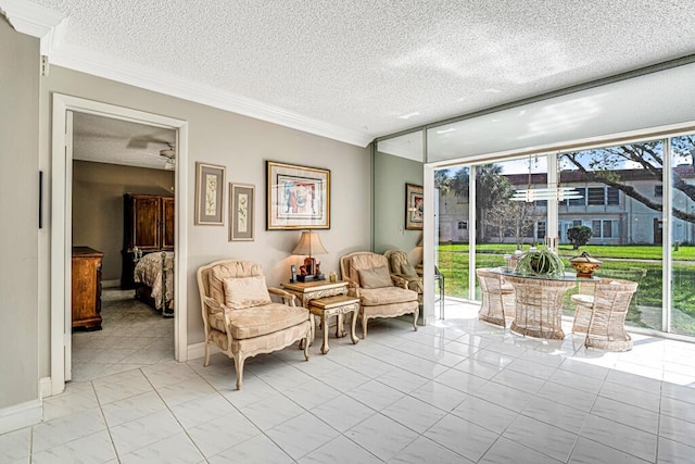 sitting room with a wealth of natural light, crown molding, and a textured ceiling