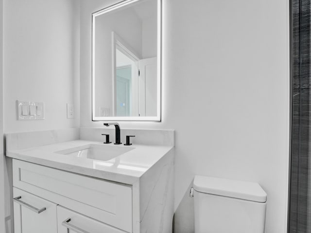 bathroom with toilet and vanity