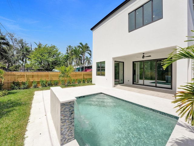 view of swimming pool with a patio area, ceiling fan, fence, and a fenced in pool