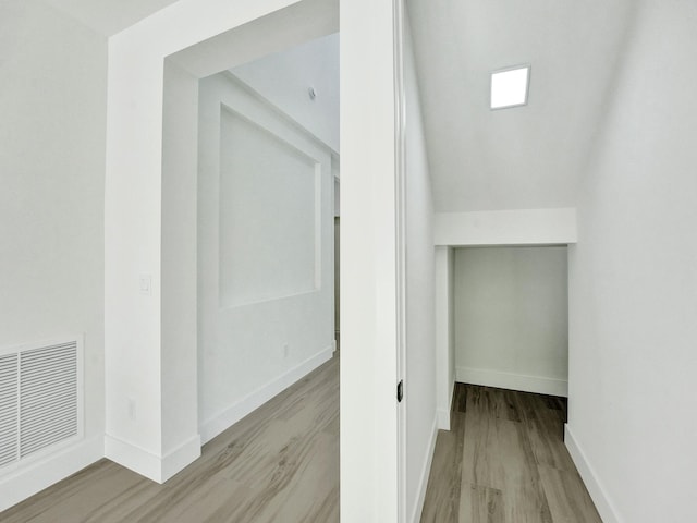 interior space featuring light wood-style floors, visible vents, and baseboards