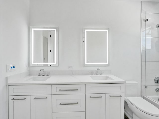 bathroom featuring toilet, shower / bath combination, double vanity, and a sink