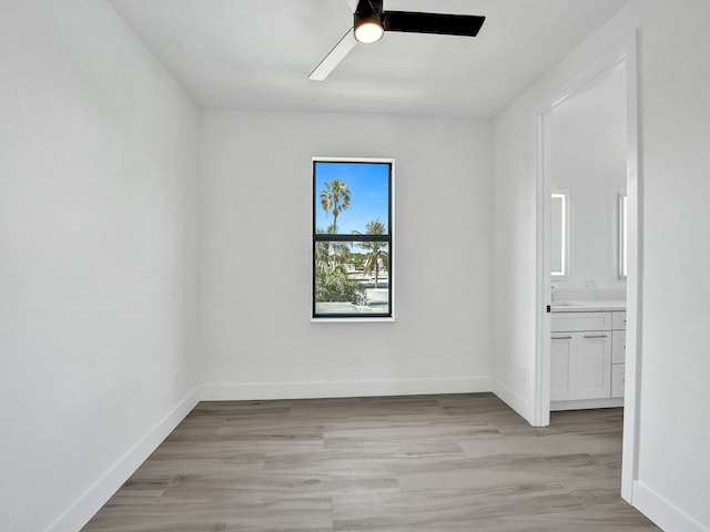 empty room featuring light wood finished floors and baseboards