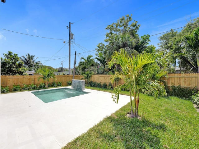 view of swimming pool featuring a fenced backyard, a fenced in pool, a lawn, and a patio