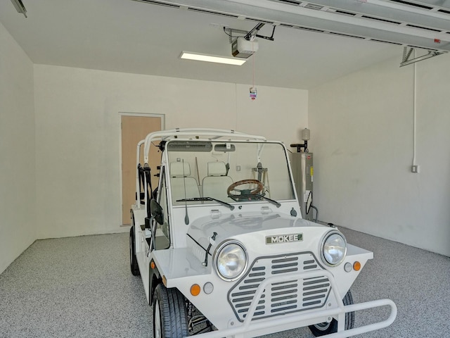 garage featuring a garage door opener and electric water heater