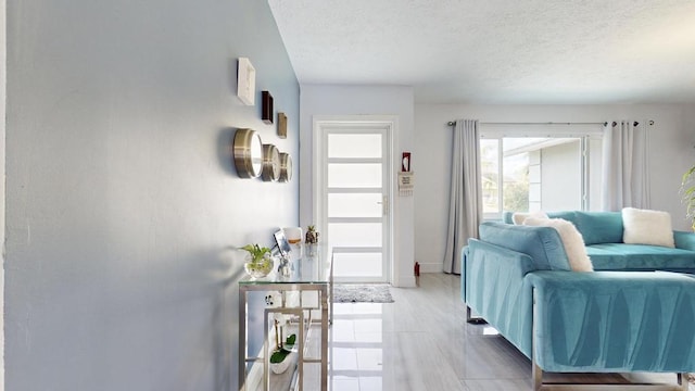 interior space featuring a textured ceiling and baseboards