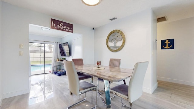 dining room featuring visible vents and baseboards