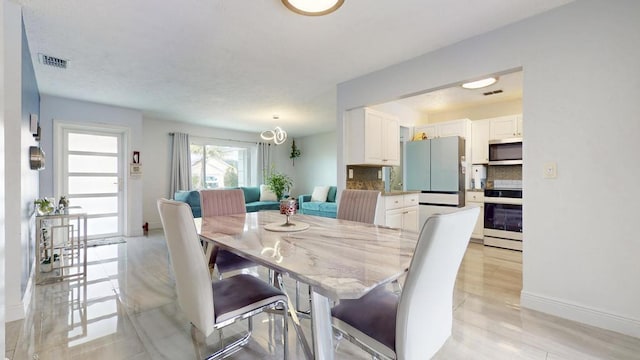 dining room with visible vents and baseboards