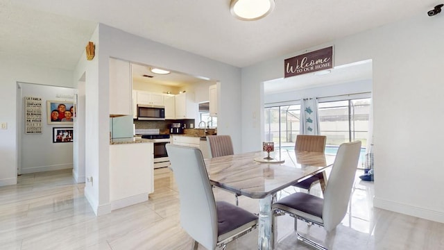 dining space with baseboards