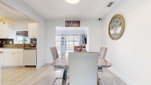 dining room featuring baseboards and visible vents