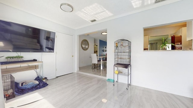 living area featuring visible vents and baseboards