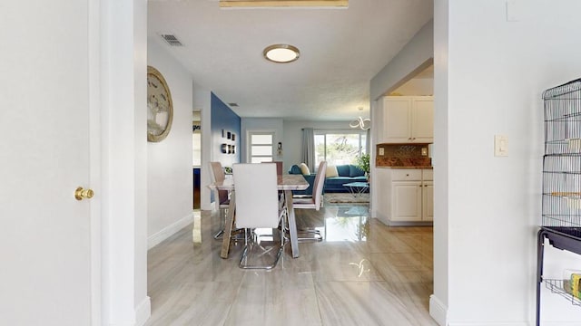 dining area with visible vents and baseboards