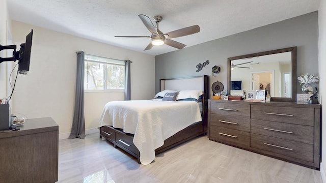 bedroom with ceiling fan and baseboards