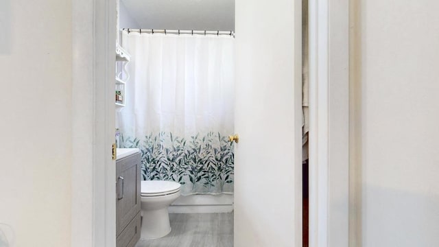 full bathroom with shower / bath combo, vanity, and toilet