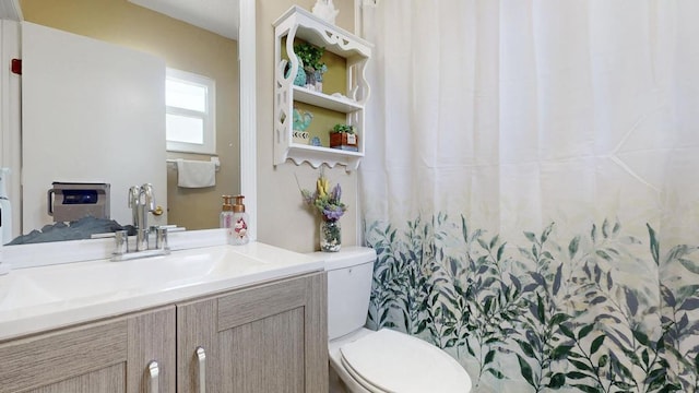 full bathroom with vanity and toilet