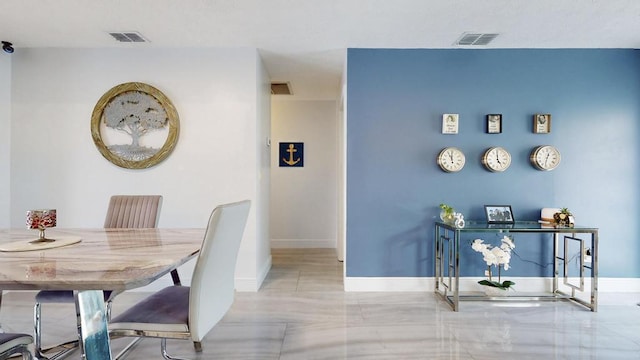 dining room featuring visible vents and baseboards