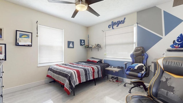 bedroom featuring ceiling fan, wood finished floors, and baseboards