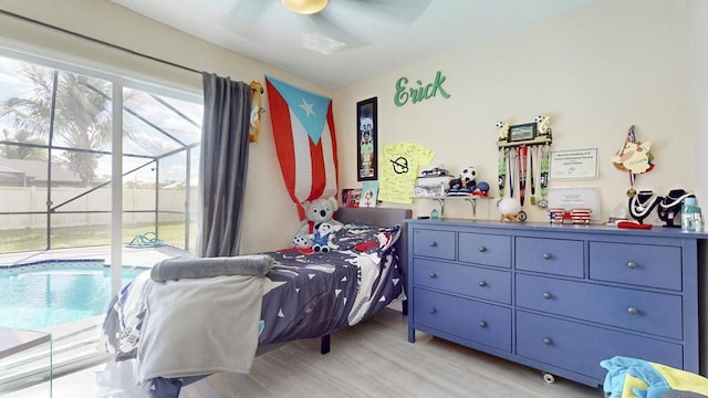 bedroom with light wood-type flooring, a ceiling fan, and access to exterior