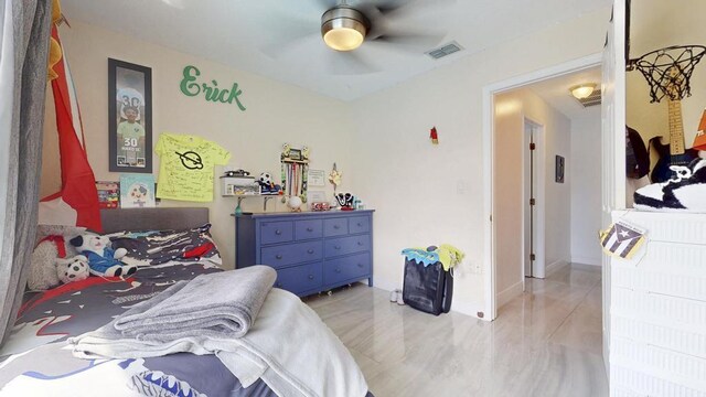 bedroom featuring ceiling fan, visible vents, and baseboards