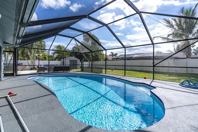 view of pool with a fenced in pool, a storage shed, a patio area, a lanai, and a fenced backyard