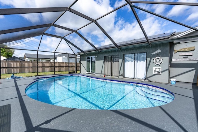 view of swimming pool featuring a fenced in pool, a lanai, fence, and a patio