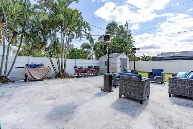 view of patio / terrace featuring a fenced backyard, an outdoor structure, an outdoor living space, and a shed