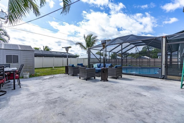 view of patio / terrace with a storage shed, a fenced in pool, a lanai, an outdoor structure, and outdoor lounge area