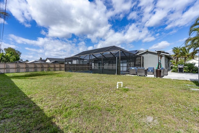 view of yard featuring a lanai, fence, and an outdoor hangout area