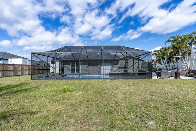 back of house featuring glass enclosure, a patio, an outdoor living space, a yard, and a fenced in pool